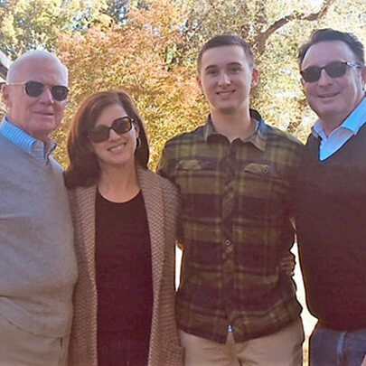 Four people smile for a photo.