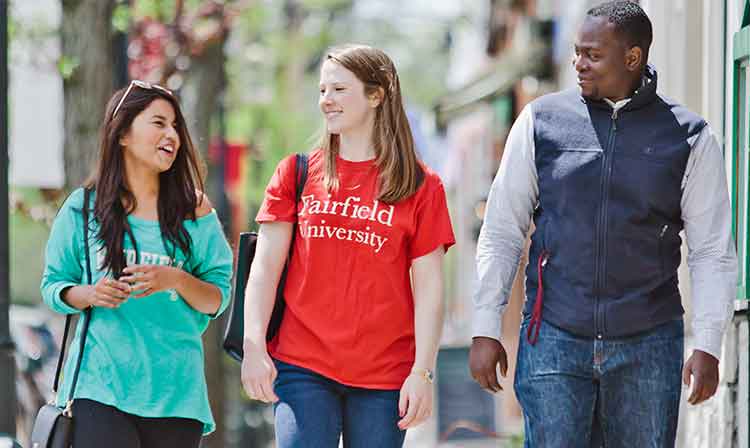 3 students walking in downtown Fairfield talking.