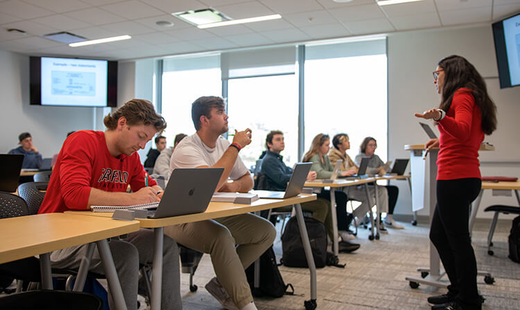 Business students take notes and listen to their professor’s lecture.