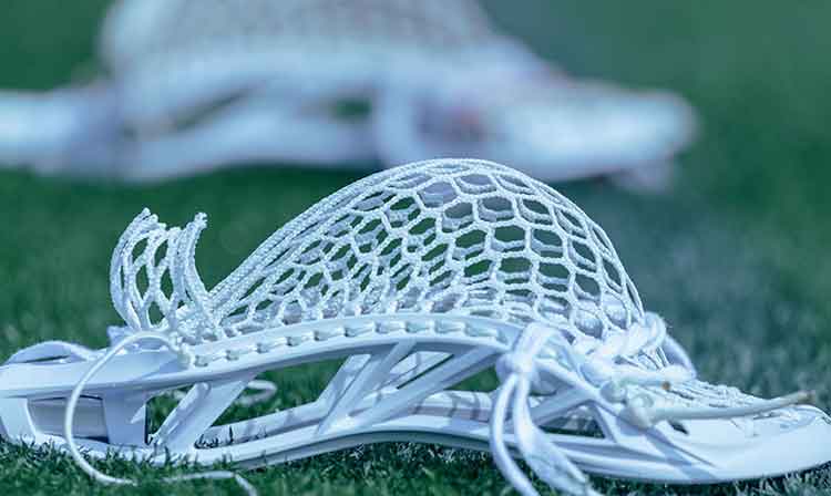 Lacrosse stick on the ground, close up shot 