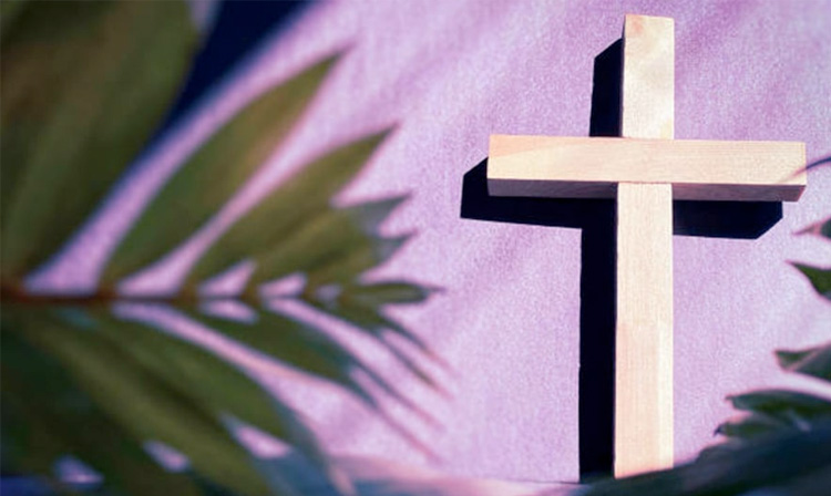 Light colored cross on purple wall.