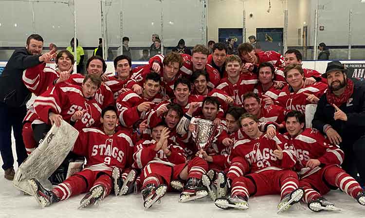 Men's hockey team celebrating their national championship victory, posing proudly for a team photo.