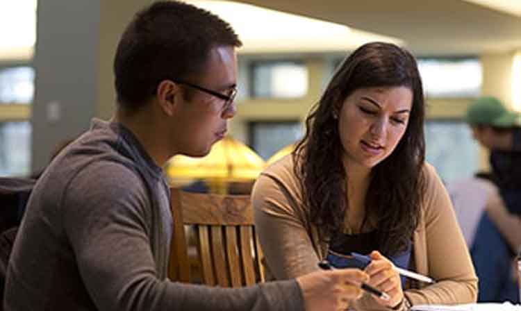 Student being tutored in the school library. 