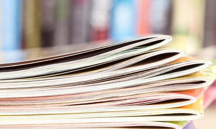 Closeup of a stack of thin books. 