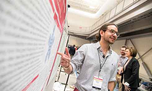 A student presenting at research symposium.