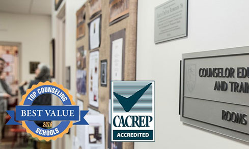 A hallway featuring a sign and bulletin board.