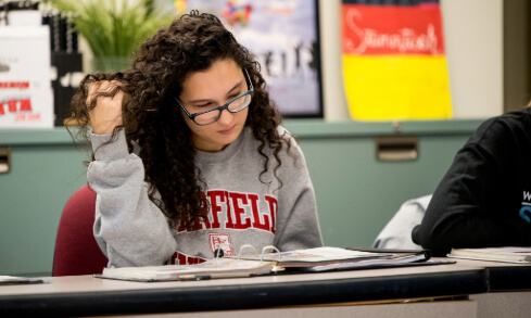 A student sits at a desk.