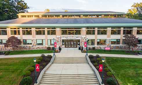 An aerial shot of the concrete pathway leading into the DiMenna-Nyselius library. 