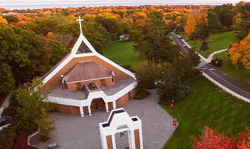 An aerial view of a church and archway.