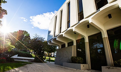 An exterior of a building with windows and blue sky.