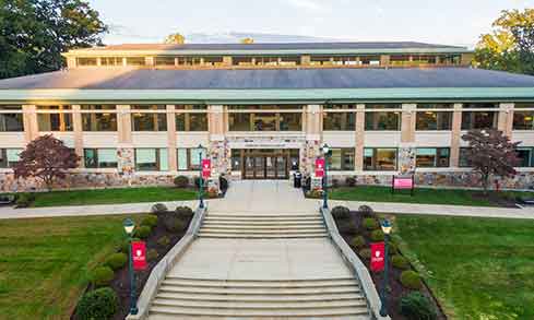 An aerial shot of a path leading into a building marked “DiMenna-Nyselius Library”.