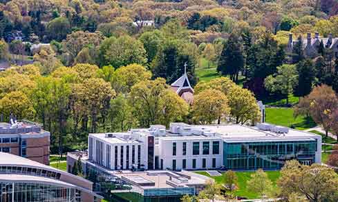 An aerial shot of buildings partly covered by trees.