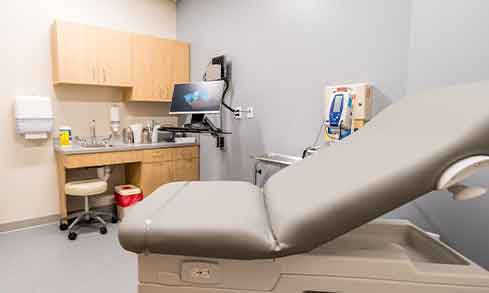 The interior of a medical exam room with equipment.