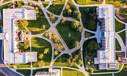 An aerial view of two buildings with pathways and a courtyard.