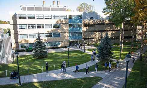 Aerial shot of students walking on stone pathways.