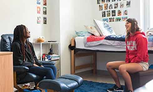 Two students laughing together in one of Fairfield’s dorms. 