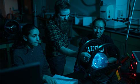 Image of students and professor in lab