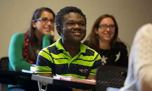 Two Fairfield students sitting behind a younger student from a Bridgeport high school. 