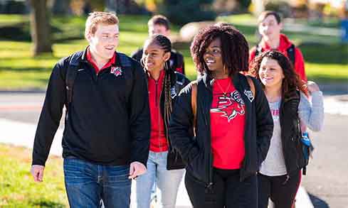 Students walking around campus together. 