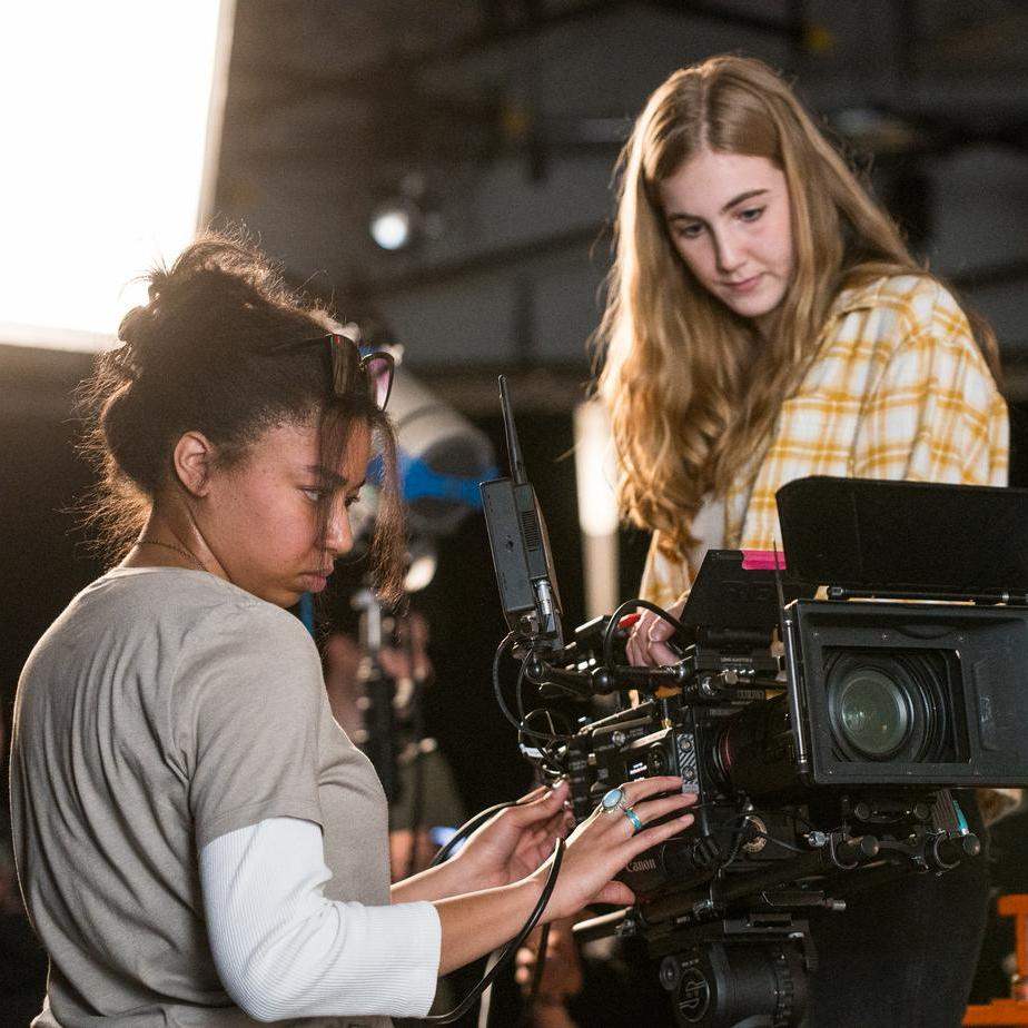 Two students work on a camera rig.