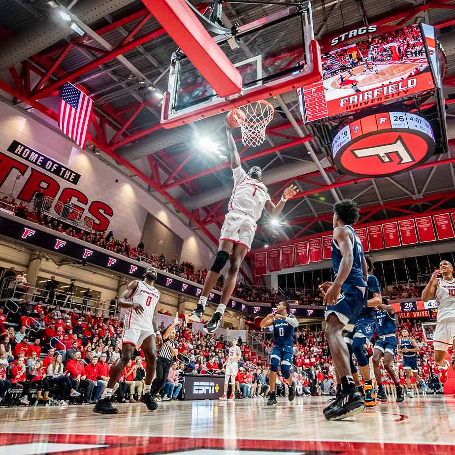 A vibrant basketball game unfolds in a spacious arena filled with enthusiastic spectators.