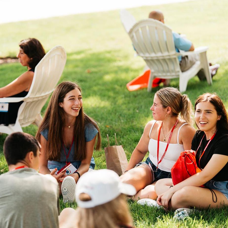 Student sit on the grass talking during Orientation day