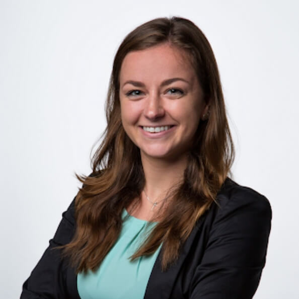 Christina Slayton smiles in front of white background.