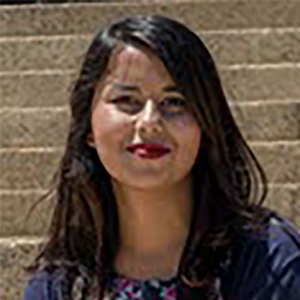 Headshot of student Samyukta in front of stone wall backdrop. 