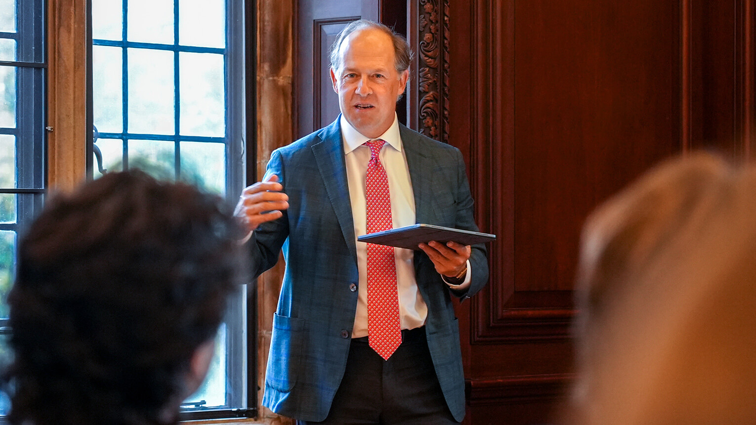 President Mark R. Nemec, PhD wearing a suit and tie is actively presenting to a group, showcasing professionalism and expertise.