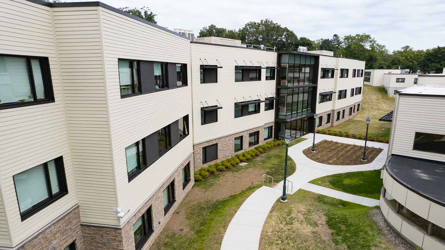 New building exterior at the Fairfield University, showcasing modern architecture and vibrant campus surroundings.