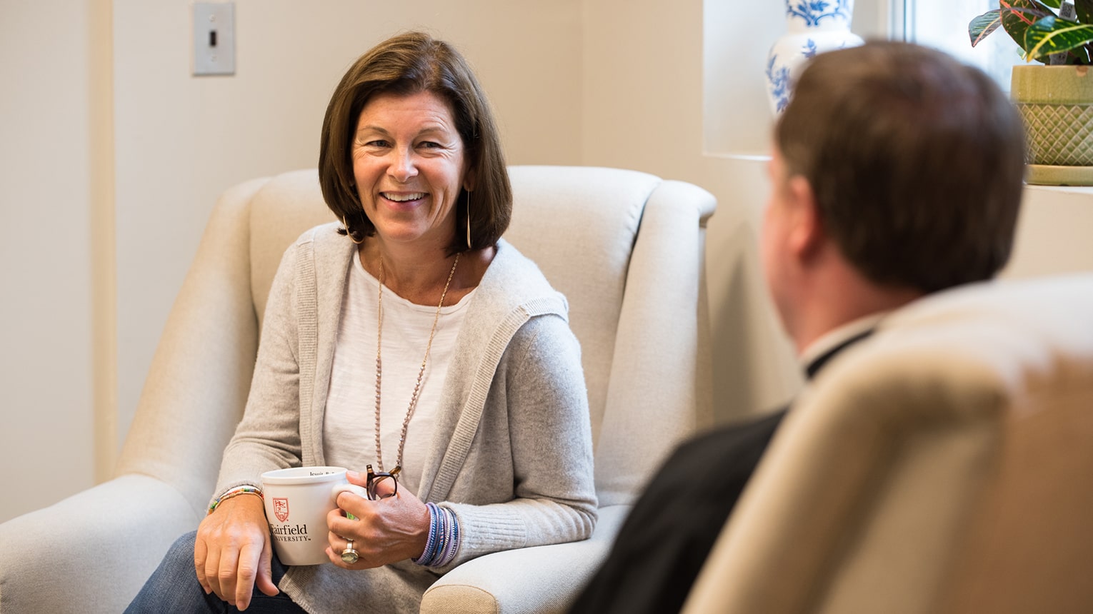 A resident Jesuit at the Murphy Center talking to a Spiritual Direction participant.