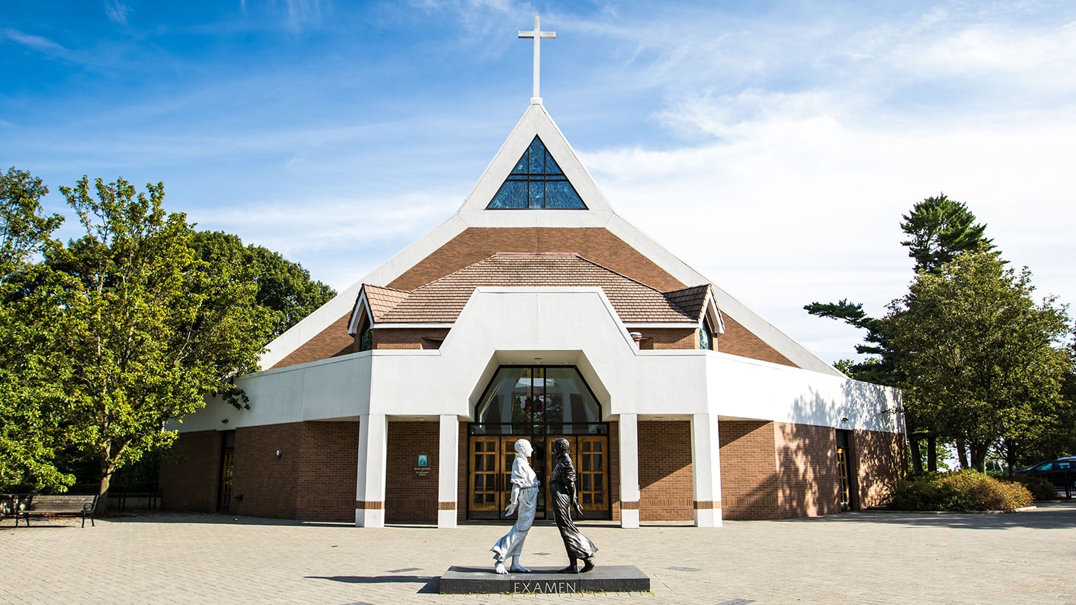 Exterior shot of the Egan Chapel plaza, including the St. Ignatius' 'Examen' reflection statue.