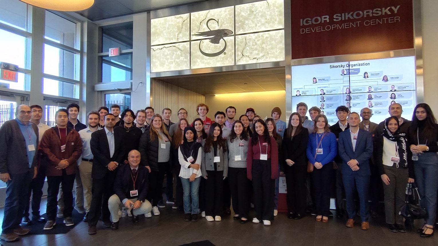 Fairfield students standing in a group for a photo in the Igor Sikorsky Development Center lobby.