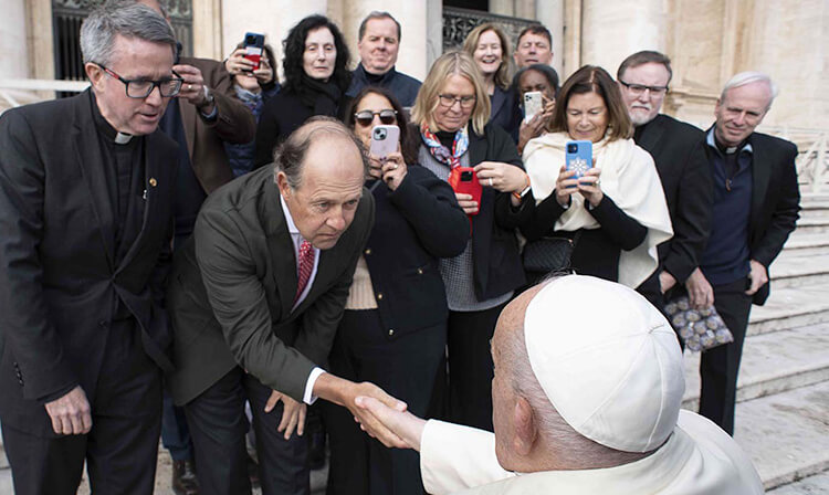 The Pope warmly greets Fairfield University leadership at the Vatican, embodying a spirit of unity and compassion.