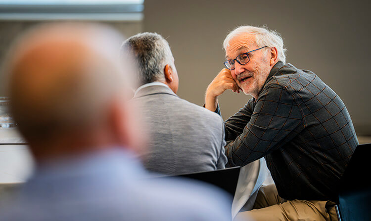 Two audience members engage in conversation.