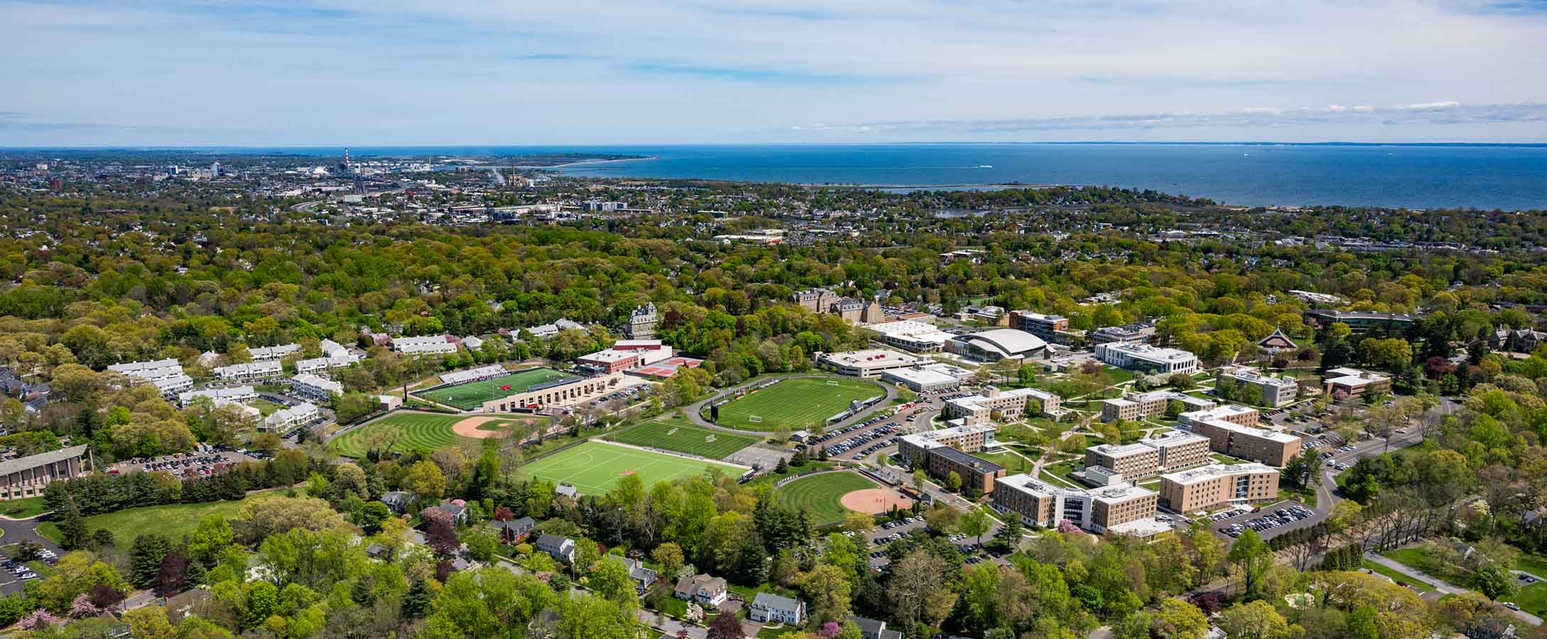 Aerial photo of Fairfield University campus with Long Island sound in the distance.