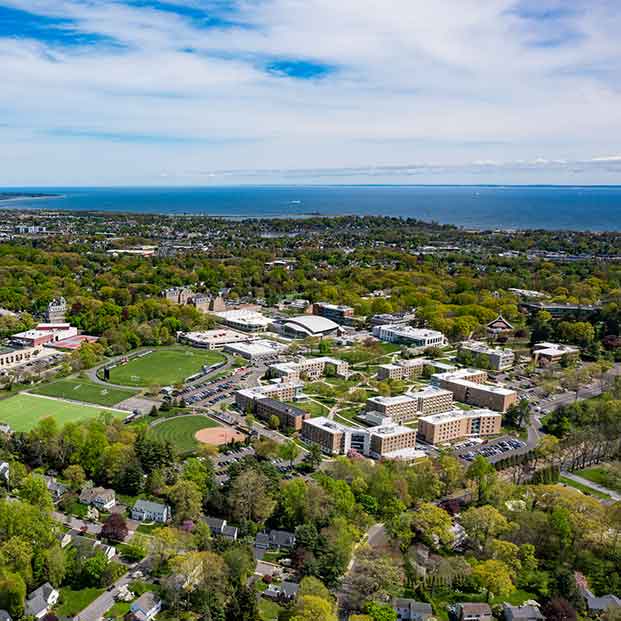 Aerial photo of newsUniversity campus with Long Island sound in the distance.