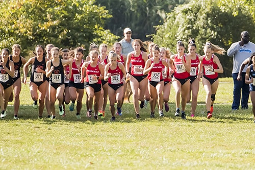 A group of runners in Fairfield jerseys begins to run.