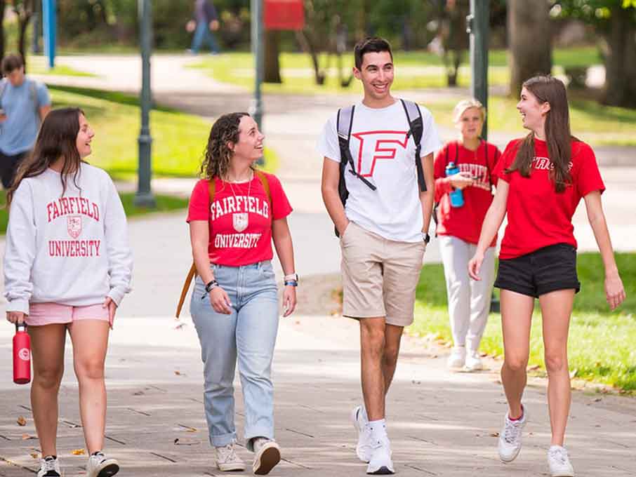 Students walking on path wearing Fairfield shirts.