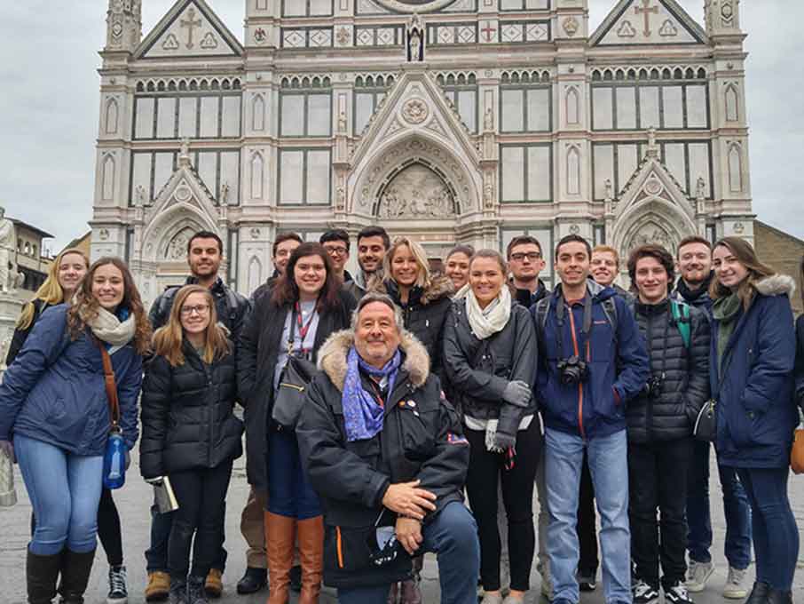 Students posing with faculty member while studying abroad.