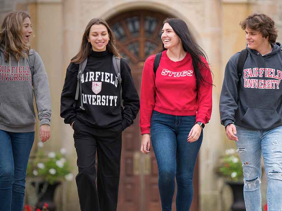 Student walking and wearing Fairfield branded clothes.