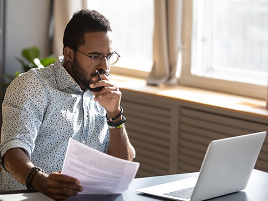 Grad student looks intently at his computer.