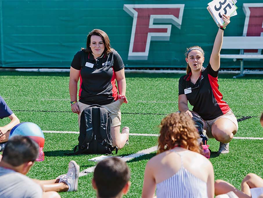 Image of students sitting on field