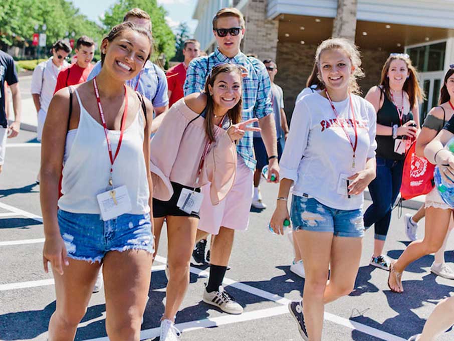 Students walking and smiling at camera.