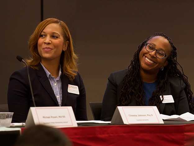 Deans Dialogue Series panelists smile on the stage.