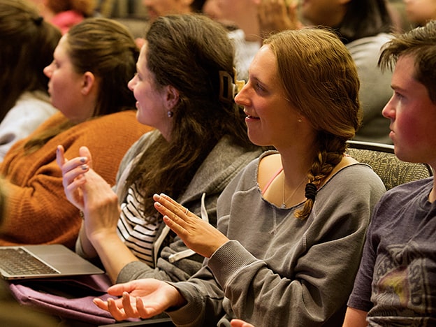 Attendees clap at Diversity Series Lecture.