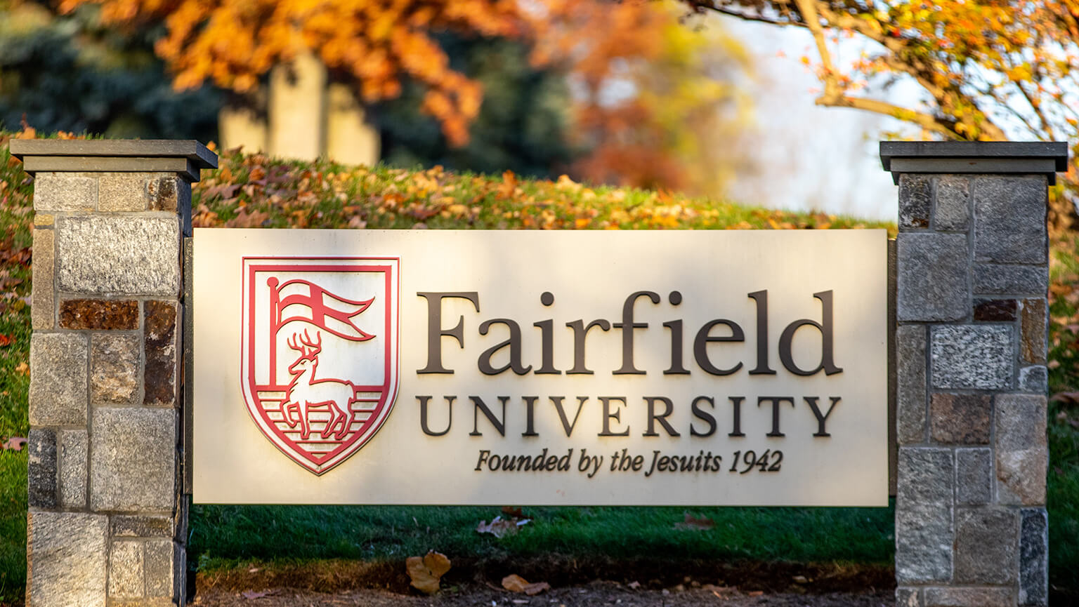 A Fairfield University sign displayed prominently on campus, showcasing the institution's name and emblem.