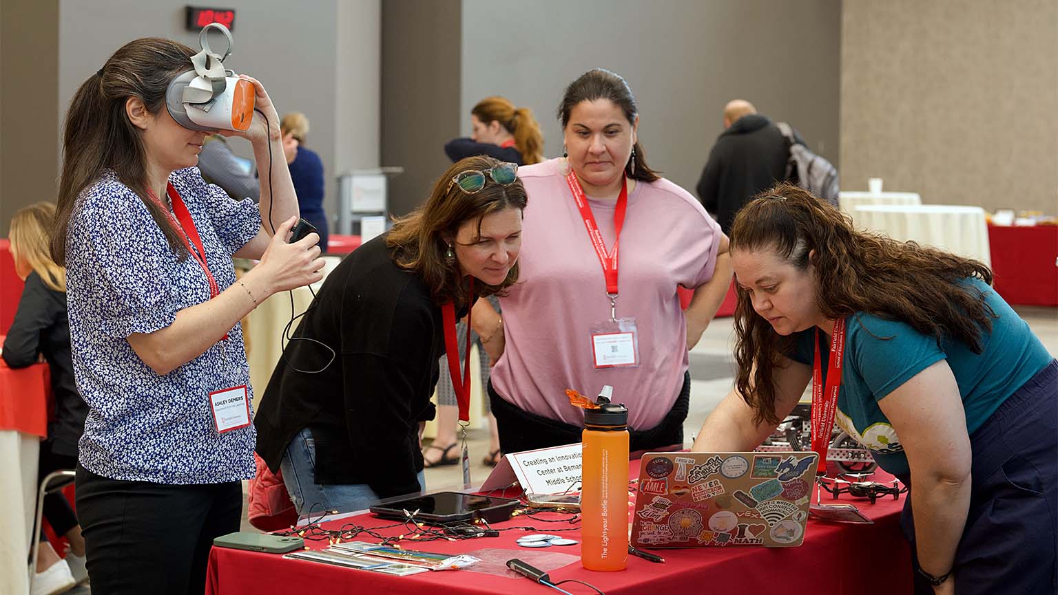 Image of people standing around table