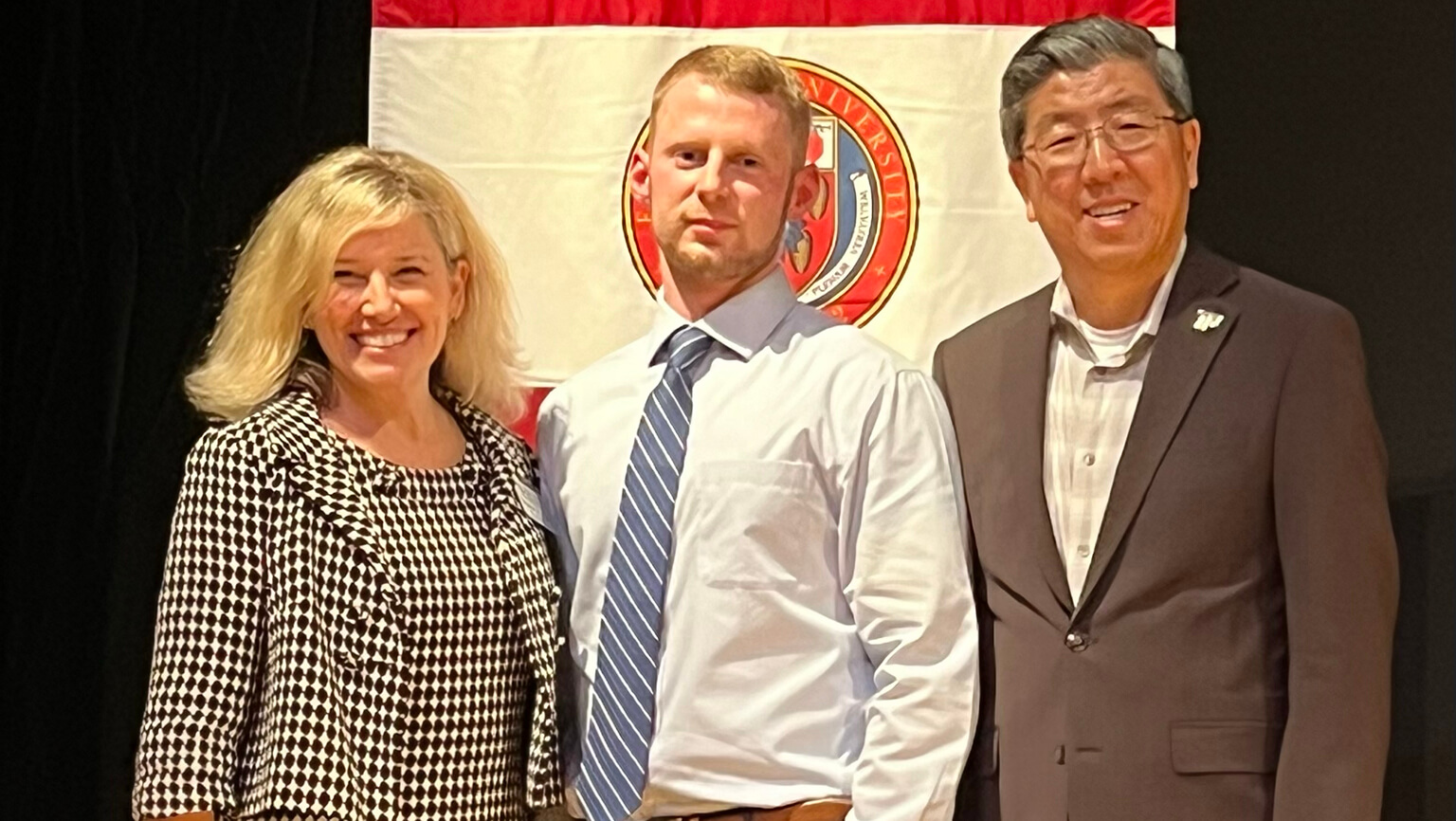 MSN/MBA graduate John Belden with Egan School Dean Meredith Kazer, PhD, APRN, FAAN, and Dolan School Dean Zhan Li, DBA.