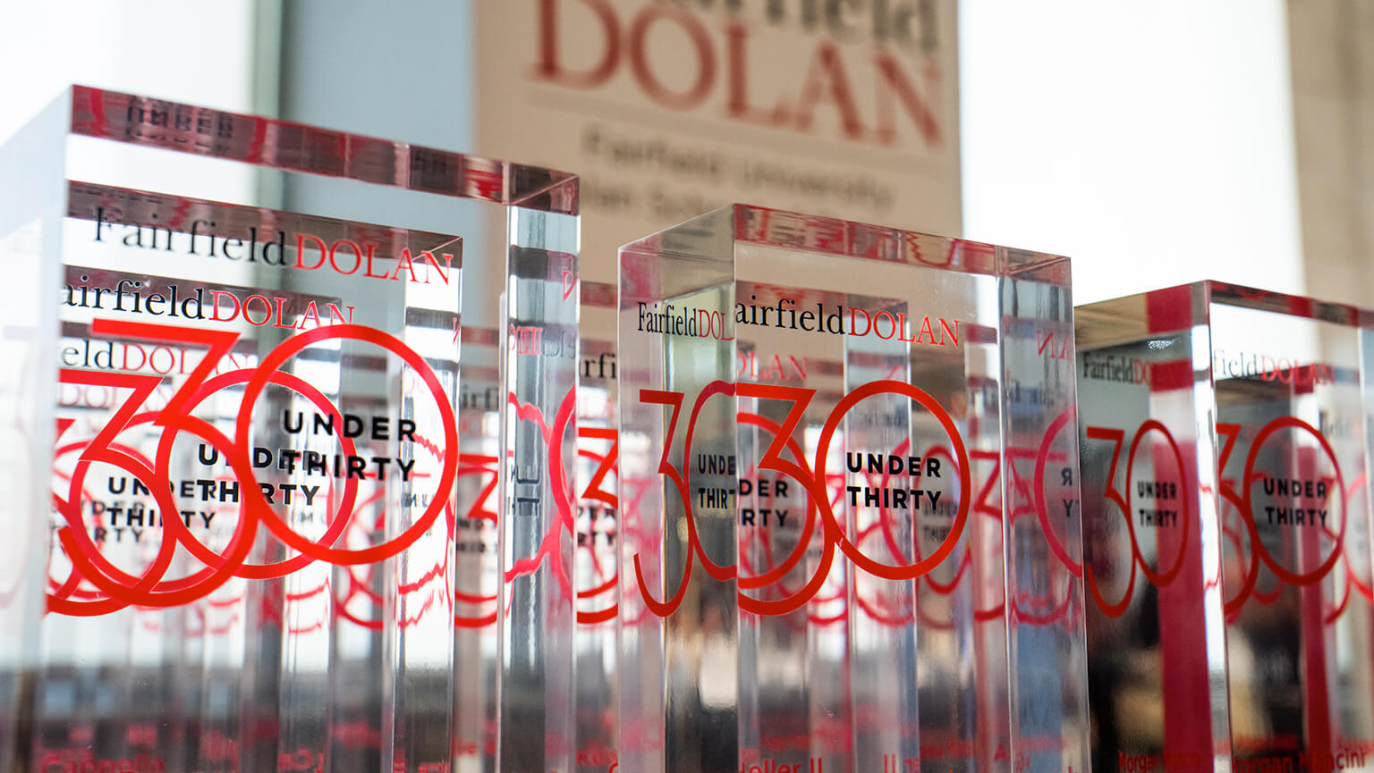 A celebration of the Fairfield Dolan 30 under 30 awards, featuring a table full of transparent awards.